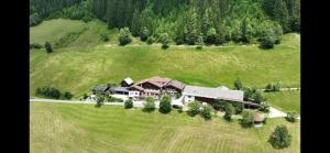 an aerial view of a large house in a field at Gsenghof in Filzmoos