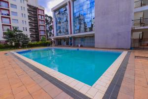 a swimming pool in the middle of a building at Ngong Road Studio, Racecourse Gardens with Free parking, Netflix &Pool, Pearl1 Luxury bnbs in Nairobi