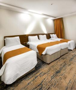 a hotel room with two beds in a room at Emaar International in Mecca