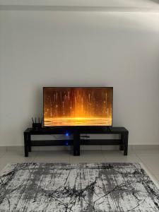 a living room with a flat screen tv on a wall at Cozy Studio in Edusentral Setia Alam in Shah Alam