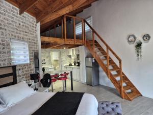 a bedroom with a loft bed and a staircase at Edel's Nest Nelspruit in Mataffin