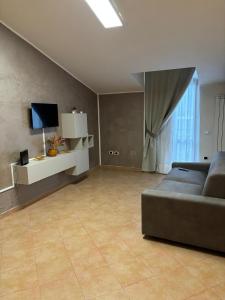 a large living room with a couch and a television at Del Golfo House in Angri