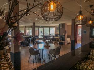 a lobby with a table and chairs in a building at Golf-Resort Brunssummerheide in Brunssum