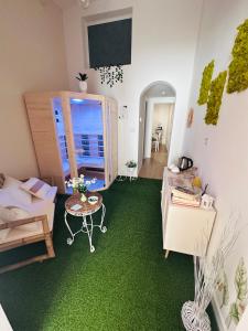 una stanza con un tappeto verde e una stanza con un tavolo di La Rosa di Candy a Brindisi