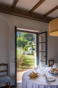 een eetkamer met een tafel en uitzicht op een tuin bij Villa Il Bagno in Bagno