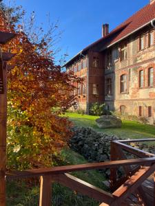 a wooden fence in front of an old building at Willa Pod Zegarem in Stara Kamienica