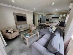 a living room with a couch and a table at Studio 6 The Studios at Churchill in Hillcrest