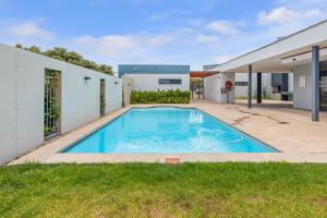 a swimming pool in the backyard of a house at Two Bedroom Luxury Apartment, Century City - BackUp Power in Cape Town