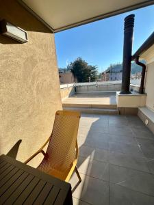 a patio with a chair and a bench on a balcony at C'era una volta un mulino in Conegliano