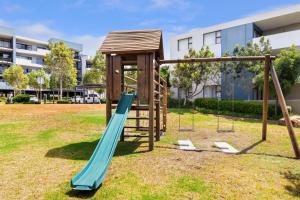 a playground in a park with a slide at Two Bedroom Luxury Apartment, Century City - BackUp Power in Cape Town