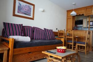 a living room with a couch and a table at Résidence Montana Premier in Val Thorens