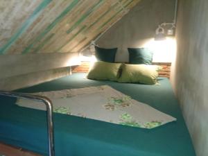 a small room with a bed in a attic at Shelter Hostel Malang in Malang