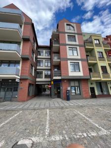 a large brick building in the middle of a street at Loft 79 Głogów in Głogów