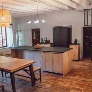 a large kitchen with a large island in a room at Domaine de Maisonneuve in Sugères