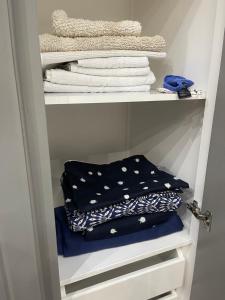 a closet with towels and towels on a shelf at Maria's luxury apartment in Athens +190 photos