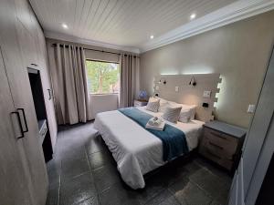 a bedroom with a large bed and a window at Studio 6 The Studios at Churchill in Hillcrest