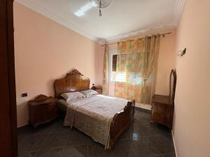 a bedroom with a large bed and a window at Saidia Appartement a Louer in Saïdia