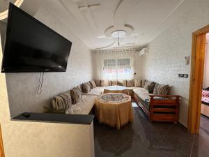 a living room with a couch and a flat screen tv at Saidia Appartement a Louer in Saïdia