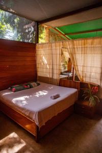 a bedroom with a bed in a tent at Coco house tambopata in Puerto Maldonado