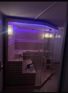 a large bathroom with a tub with purple lights at B-Willa Słopnice basen & jacuzzi, sauna in Słopnice