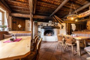 a dining room with a table and a fireplace at Gsenghof in Filzmoos