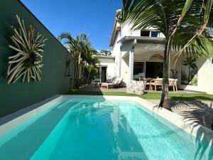 a swimming pool in front of a house at Ti Pêcheurs vb Bord de mer in Saint-Pierre