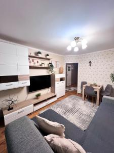 a living room with a couch and a table at Apartament Sieroszewskiego in Puławy