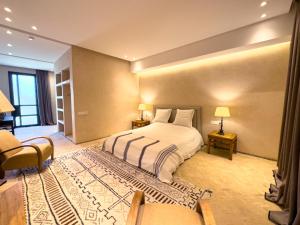 a large bedroom with a bed and a couch at Villa A Atlas Retreat Luxury B and B Beni Mellal in Beni Mellal