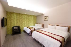 Postel nebo postele na pokoji v ubytování 宜都大飯店 Idol Hotel