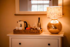 a table with a lamp on top of a dresser at Gallows Hill in Scarborough