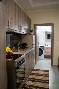 a kitchen with a sink and a stove top oven at Nastas-Home in Igoumenitsa