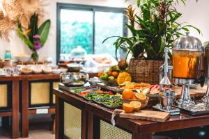 a buffet with fruits and vegetables on a table at Dolphin Village - Sea Resort By Ran Hotels in Shave Ẕiyyon