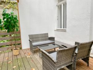 a patio with two chairs and a table and a bench at Cosy Apartment with Terrace & Free Parking in Vienna