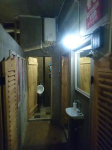a small bathroom with a sink and a mirror at Shelter Hostel Malang in Malang