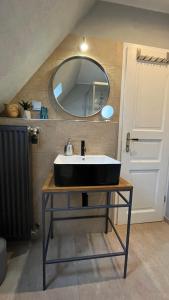 a bathroom with a black sink and a mirror at Ferienhaus an der KIostermauer in Speyer