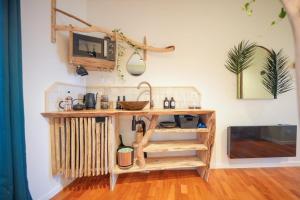 a kitchen with a wooden counter with a sink at Kanopya in Lacanau