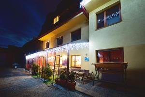 a building with christmas lights on the side of it at Tavel boutique hotel in Prešov