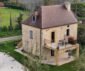 a house with a porch and a deck at le chant des Verdiers in Saint-Aubin-de-Nabirat