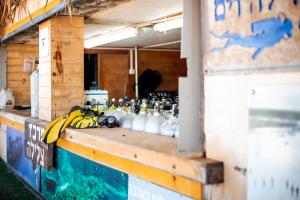 a counter with bottles of water and bananas on it at Dolphin Village - Sea Resort By Ran Hotels in Shave Ẕiyyon