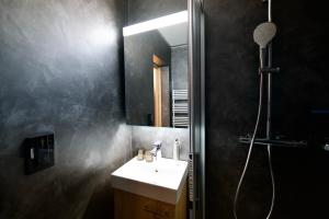 a bathroom with a sink and a shower at Studio NINNI in Zermatt +7 photos