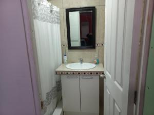 a bathroom with a sink and a mirror at Guesthouse Playa Chinchorro in Arica +35 photos