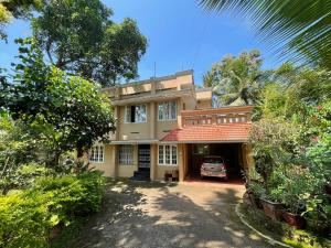 a house with a car parked in front of it at Yume No Yado - The Dream Inn in Trivandrum
