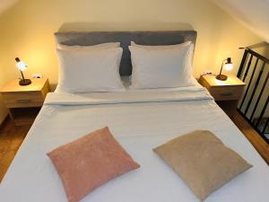 a large white bed with two pillows on it at Vila Dvorište in Banja Luka