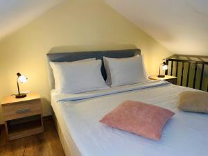 a bedroom with a large bed with white pillows at Vila Dvorište in Banja Luka
