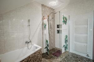 a bathroom with a shower and a bath tub at Penzión Gaboltov in Gaboltov +80 photos