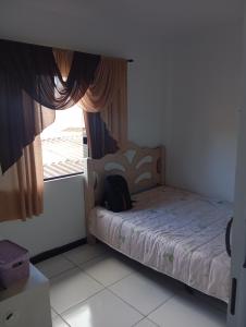 a small bedroom with a bed and a window at Casa de férias Branvek in Brusque +14 photos