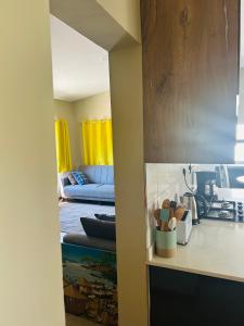 a living room with a blue couch and a kitchen at Grey Lavender in Chelston +13 photos