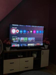 a large flat screen tv sitting on top of a cabinet at Seaside Serenity in Mahabalipuram