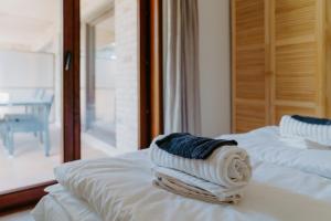 a stack of towels sitting on top of two beds at Prachtig, rustig en ruim appartement vlakbij zee in Koksijde