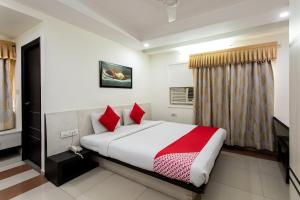 博帕尔Hotel O Mohit Regency的卧室里有一张大床，配有红色枕头